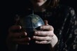 © altitudevisual - closeup shot of an unidentifiable woman holding a globe
