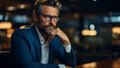 © D-stock photo - Thoughtful businessman in eyeglasses looking away while sitting in cafe
