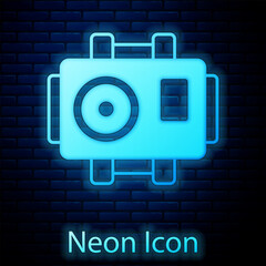 Poster - Glowing neon Photo camera for diver icon isolated on brick wall background. Foto camera icon. Diving underwater equipment. Vector