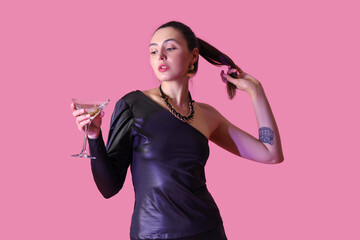 Wall Mural - Beautiful woman with martini on pink background