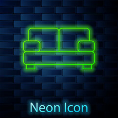 Sticker - Glowing neon line Sofa icon isolated on brick wall background. Vector