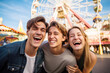 © Jasmina - : Happy young friends having fun in amusement park Prater in Vienna