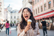 © Jasmina - Smiling young Japanese woman with ice cream having fun in amusement park Prater in Vienna at her holiday in Europe