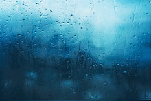 Close Up Image Of An Icy Blue Wet Glass Window, Water Drops, The Rain On The Window Glass.
