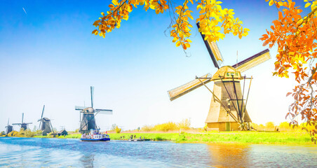 Wall Mural - dutch windmill over river waters