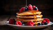  a delicious stack of pancakes topped with syrup and berries on a plate
