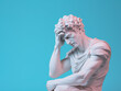 Ancient Greek sculpture of thinking man.