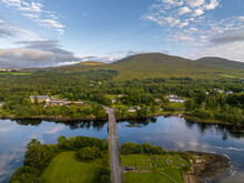 Aerial Panorama View Of Kenmare Bay At The Entrance Of The Ring Of Kerry In Ireland, Our Lady's Bridge Crossing The Water, Stunning Colorful Sunset Reflecting Off The Water
