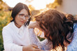 © Erika - Concerned aged mother and adult daughter sitting on the sofa having a serious conversation, young woman talking to worried elderly mother, listening to her problems or concerns, helping cope with depr
