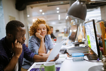 Wall Mural - Young and diverse group of people working together in the office of a startup company