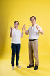 © 1112000 - portrait of middle aged asian couple posing on yellow background