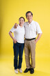 © 1112000 - portrait of middle aged asian couple posing on yellow background