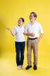 © 1112000 - portrait of middle aged asian couple posing on yellow background