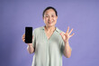 © 1112000 - Gangang middle-aged Asian female portrait posing on purple background