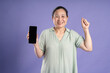 © 1112000 - Gangang middle-aged Asian female portrait posing on purple background