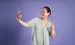© 1112000 - Gangang middle-aged Asian female portrait posing on purple background