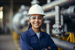 © AspctStyle - Portrait of happy female engineer at oil refinery, woman engineer inspecting in industrial oil refinery wearing construction helmet and blue vest