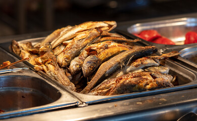 Wall Mural - Fried fish on a tray in a restaurant