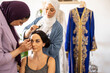 © Westend61 - Hairdresser and make-up artist preparing bride for wedding in boutique