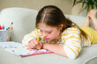 © Westend61 - Teenage girl with down syndrome doing homework at home