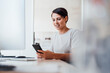 © Westend61 - Businesswoman using smart phone at desk in workplace