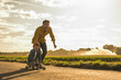 © Westend61 - Happy boy enjoying skateboarding by grandfather on sunny day
