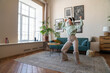 © Westend61 - Cheerful woman wearing wireless headphones dancing at home