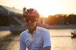 © nuclear_lily - Man is wearing protective helmet, sunglasses and sportswear during evening ride in city.