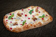 Pizza Four Cheese with smoked suluguni, gorgonzola, mozzarella, mountain ash, walnuts, honey, basil Roman pizza rectangular on wood background