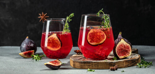 Autumn or winter fig cocktail in glass with thyme. Long banner format