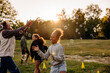 © Maskot - Girl playing amidst bubbles with friends in playground at summer camp