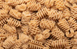 © cristianstorto - Background of Italian wholemeal radiatori type pasta