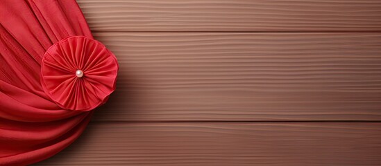Poster - Red fabric brooch with threads on isolated pastel background Copy space en table resembling a mockup
