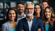 © AS Photo Family - Portrait of happy business team looking at camera and smiling in office.