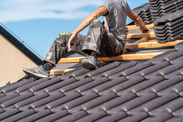 Wall Mural - installation of roofing by a craftsman, ceramic tiles on wooden beams