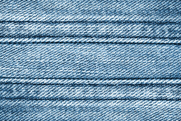 Wall Mural - Blue jeans texture. Denim background. Brown thread sew. Textile pattern. Fabric strap. Straight line thread.