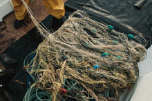 Heap Of Tangled Fishing Net On Deck Of Sailboat In Daylight
