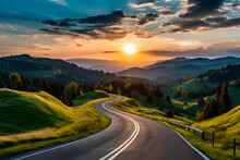 A  Winding Road Going Into The Distance By The Setting Sun, Mountains On The Horizon, Green Hills And Forest On The Sides