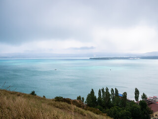 Wall Mural - above view of Lake Sevan from Sevanavank monastery on cloudy summer day, Armenia