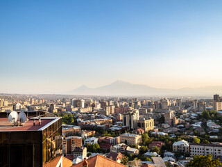 Wall Mural - above view of Yerevan city and mountain on horizon from Cascade stairs on summer sunset