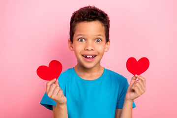 Poster - Photo portrait of сute little boy excited hold two red postcards date dressed stylish blue clothes isolated on pink color background