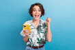 Photo of overjoyed ecstatic impressed girl dressed colorful blouse holding smartphone win lottery isolated on blue color background