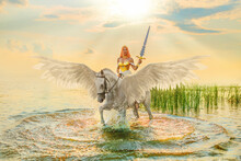 Art Photo Real People Fantasy Woman Warrior Queen Sits Astride White Horse With Wings Goddess Girl Rides Pegasus Animal. Princess Holds Magic Sword In Hands Walks In Water River Sea Lake Sun Light Sky