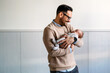 © NDABCREATIVITY - Portrait of a father hugging and kissing newborn baby. Authentic lifestyle touching tender moment.