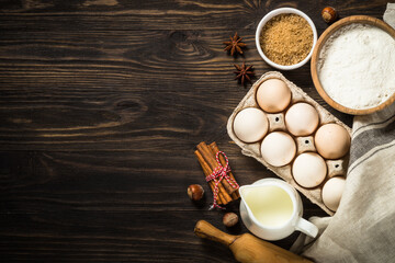 Wall Mural - Ingredients for cooking baking - flour, sugar, milk and spices. Top view at rustic wooden table.