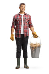 Sticker - Full length portrait of a farmer holding a bucket with hay