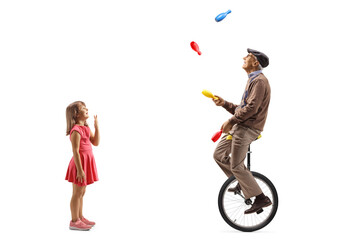 Poster - Excited little girl watching an elderly man juggling on a mono cycle