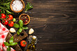 Ingredients for cooking. Food background with spices, herbs and vegetables at wooden kitchen table. Top view with copy space.