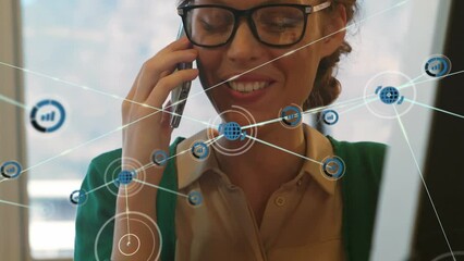 Poster - Animation of network of digital icons over happy caucasian woman talking on smartphone at office