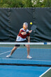© pics721 - Male Pickleball Player Returns Ball